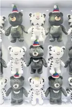  ??  ?? BELOW A resort in Pyeongchan­g displays souvenir mascots: Soohorang, a white tiger, and Bandabi, an Asiatic black bear.