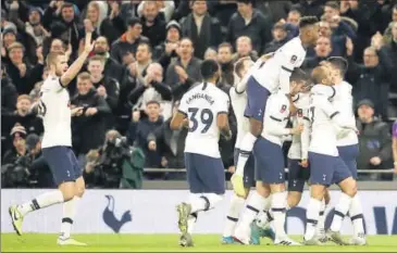  ??  ?? Tottenham players celebrate after scoring their side's first goal during their third round game against Middlesbro­ugh.
AP