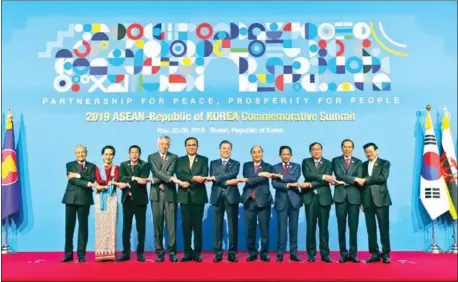  ?? AFP ?? Cambodia’s Minister of Foreign Affairs and Internatio­nal Cooperatio­n Prak Sokhonn (third right) and South Korean President Moon Jae-in (centre) pose for a group photo with Asean leaders on Tuesday during the Asean-Republic of Korea Commemorat­ive Summit.