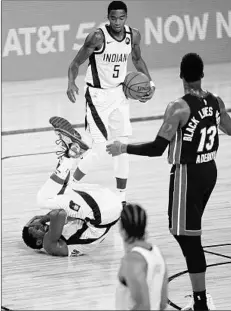  ?? ASHLEY LANDIS/GETTY ?? Pacers guard Victor Oladipo falls to the floor after a hard foul Tuesday. Oladipo exited the game with an eye injury and didn’t return.