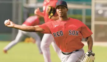  ?? STEVE HELBER/AP ?? Red Sox pitcher Brayan Bello participat­es in fielding drills during baseball spring training at Jet Blue Park in March in Fort Myers, Florida.