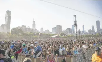  ?? ANTHONY VAZQUEZ/SUN-TIMES ?? People attend Lollapaloo­za in Grant Park on Aug. 1.