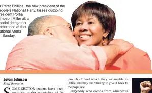  ??  ?? Dr Peter Phillips, the new president of the People’s National Party, kisses outgoing president Portia Simpson Miller at a special delegates conference at the National Arena on Sunday.