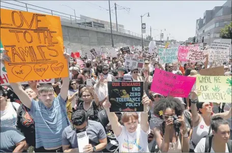  ?? Luis Sinco Los Angeles Times ?? IMMIGRANTS RIGHTS demonstrat­ors march down Alameda Street toward a federal detention facility in downtown L.A. on Saturday.