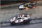  ?? BRIAN LAWDERMILK PHOTOS / GETTY IMAGES ?? Denny Hamlin (bottom) holds off Matt DiBenedett­o (top) in the closing laps of the Bass Pro Shops NRA Night Race at Bristol Motor Speedway on Saturday in Bristol, Tennessee.