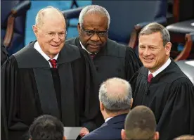  ?? DREW ANGERER/GETTY IMAGES 2017 ?? Supreme Court Justice Anthony Kennedy (left) — standing with Justice Clarence Thomas (center) and Chief Justice John Roberts — will retire July 31. Roberts will fill Kennedy’s role as the “median justice” on the court.