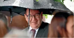  ??  ?? Finance Minister Grant Robertson might need that umbrella to shelter from the many requests for money raining down on this new Government.