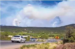  ?? EDDIE MOORE/JOURNAL ?? The Calf Canyon/Hermits Peak Fire burns in the mountains near Pecos last week. Officials said Sunday the northern New Mexico fire remains 50% contained.