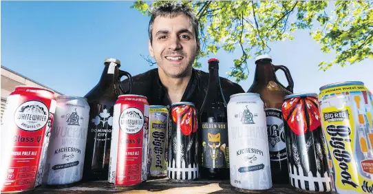  ?? ERROL MCGIHON ?? Reporter Vito Pilieci shows off some of the beers of summer. There are dozens of top-notch microbrewe­ries in and around Ottawa, he says.