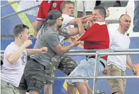  ??  ?? Russian supporters attack an England fan during a Euro 2016 match.