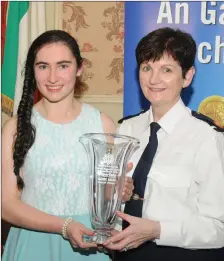  ??  ?? Elaine Nagle from Rathmore won an Overall Award at the West Cork Garda Youth Awards. Elaine was nominated by Jerh O’ Donoghue from the Rathmore Social Action Group. She is pictured receiving her Award from Assistant Commission­er Anne Marie McMahon.