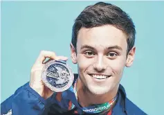  ??  ?? Tom Daley of Britain poses with his bronze medal on the podium during the victory ceremony for the men’s 10m platform final at the 16th FINA World Championsh­ips at the Aquatics Palace in Kazan in this Aug 2, 2015 file photo. — AFP photo