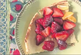  ??  ?? A Dutch Baby puffed pancake is a great vessel for holding fresh strawberri­es.