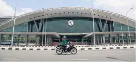  ?? ARNUN CHONMAHATR­AKOOL ?? A motorcycli­st drives past Bang Sue Grand Station in Bangkok, which opened in August this year.