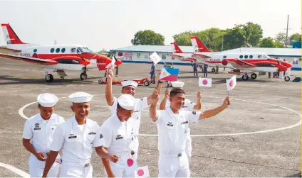  ?? AP FOTO ?? GRATEFUL: Philippine Nave personnel celebrate during the formal turnover of three Beechcraft TC90 aircrafts from Japan Ministry of Defense at the Sangley Point in Cavite.