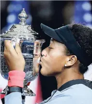  ?? AP ?? Naomi Osaka, of Japan, kisses the trophy after defeating Serena Williams in the women’s singles final at the US Open tennis tournament yesterday.