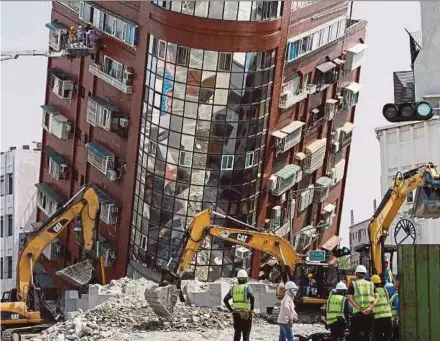  ?? REUTERS PIC ?? A general view as workers carrying out operations at the site where a building collapsed, following the earthquake, in Taiwan’s Hualien County yesterday.