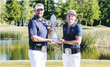  ?? Agencies ?? ↑
Cameron Smith and Marc Leishman hold up the Zurich Classic trophy after winning the final round of the Zurich Classic.