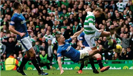  ?? Photograph: SNS ?? Clint Hill flies into a challenge on Leigh Griffiths during the last Old Firm derby