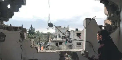  ?? ?? A young man clearing the rubble from inside a building damaged by Israeli bombing in Rafah in the southern Gaza Strip yesterday. PHOTO: AFP