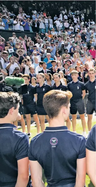  ??  ?? Centre of attention: Novak Djokovic shows off the Wimbledon trophy