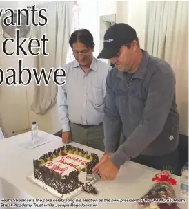  ??  ?? Heath Streak cuts the cake celebratin­g his election as the new president of the Old Mutual Heath Streak Academy Trust while Joseph Rego looks on