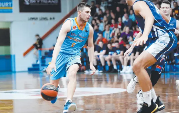  ?? Picture: STEWART McLEAN ?? COMBINATIO­N: Marlins play Anthony Fisher, pictured in action against the Rockhampto­n Rockets, says a consistent roster is their key to success.