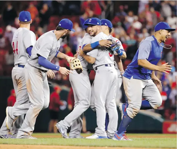  ?? — THE ASSOCIATED PRESS ?? Members of the defending World Series champion Chicago Cubs celebrated after defeating the rival St. Louis Cardinals 5-1 to clinch the National League Central title Wednesday night in St. Louis.