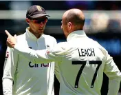  ?? GETTY IMAGES ?? In a spin: Root talks to Leach