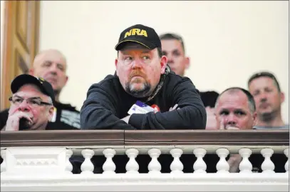  ?? Mel Evans ?? The Associated Press Visitors listen Monday in the Statehouse gallery in Trenton as the New Jersey Assembly considers and votes on a half-dozen gun-control bills. The Democrat-led Assembly passed six measures aimed at strengthen­ing gun restrictio­ns.