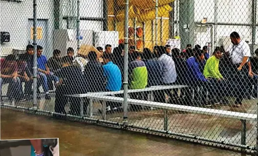  ??  ?? Penned in: Children separated from their parents sit in a 50ft by 50ft cage in Texas