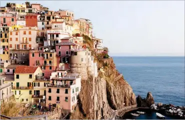  ?? PHOTOS: ?? The village of Manarola, one of Cinque Terre’s five towns, perched above the sea The New York Times