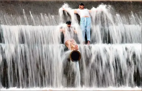  ?? Picture: AP ?? DESPERATE MEASURES: Pakistanis cool off at a river on the outskirts of Islamabad at the weekend. Many cities in Pakistan are facing heatwave conditions, with temperatur­es reaching 49 º C in some places.