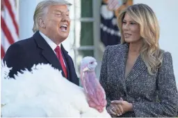  ?? SUSAN WALSH/AP ?? First lady Melania Trump looks on as President Donald Trump pardons Corn, the national Thanksgivi­ng turkey, at the White House on Tuesday.