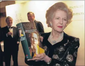  ?? Picture: REUTERS ?? HER OWN WORDS: Baroness Thatcher holds a copy of her new book at a launch attended by members of the British-American Chamber of Commerce in November 1997.