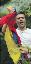  ??  ?? Opposition leader Leopoldo Lopez holds a Venezuelan national flag as he greets supporters outside his home in Caracas on Saturday.