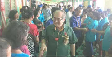  ??  ?? Uggah and other guests being greeted by residents of Rh Benang Pilang at the function.