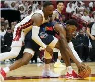  ?? MARTA LAVANDIER — THE ASSOCIATED PRESS ?? Philadelph­ia 76ers forward Paul Reed (44) and Miami Heat center Bam Adebayo (13) go after a loose ball during the first half of Game 1 of an NBA basketball second-round playoff series, Monday, May 2, 2022, in Miami.