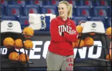  ?? ?? Arizona Daily Star via AP UNLV coach Lindy La Rocque smiles while watching the team shoot layups during practice for the NCAA women’s college basketball tournament , March 18, in Tucson, Ariz.