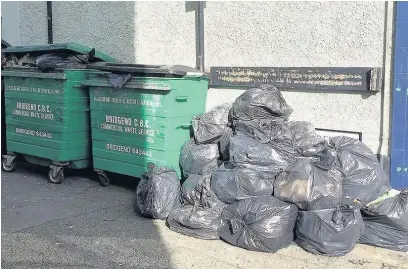  ??  ?? Trade waste bins are overflowin­g in Bridgend town centre after the council transferre­d the service to an external company