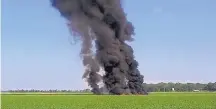  ?? COURTESY OF JIMMY TAYLOR ?? Smoke and flames rise from the wreckage after a military transport plane crashed into a field Monday near Itta Bene, Miss., on the western edge of Leflore County.