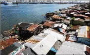  ?? SEONG JOON CHO / BLOOMBERG 2015 ?? Slum housing stands along the shoreline in Manila, Philippine­s, across the bay from more prosperous areas of the capital. A new ID plan may help many of the poorest residents.