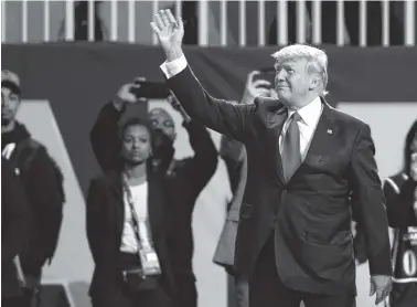  ??  ?? President Donald Trump waves to the crowd before the national anthem Monday. Trump stayed for the first half.