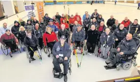  ??  ?? Good competitio­n South Lanarkshir­e Wheelchair Curling Club president Brian Douglas (front) with competing teams at the Tunnock’s Wheelchair Curling tournament