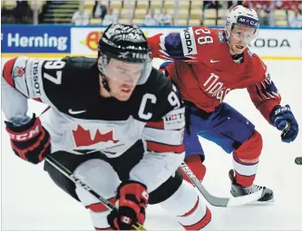  ?? PETR DAVID JOSEK THE ASSOCIATED PRESS ?? Canada’s Connor McDavid is chased by Norway’s Niklas Roest during a world hockey championsh­ip Group B game on Thursday at the Jyske Bank Boxen Arena in Herning, Denmark, on Thursday. McDavid got his first goal at 1:23 of the first and went on to score...