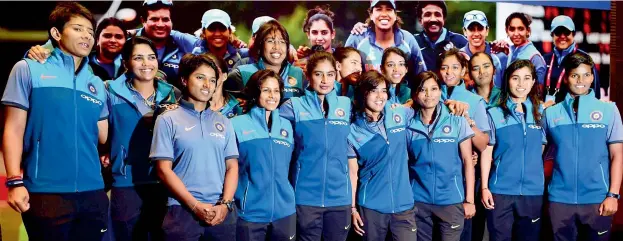  ?? — PTI ?? GO GIRLS: Members of the Indian women’s cricket team are all smiles as they pose for a photo after arriving in Mumbai on Wednesday from London where they finished runners-up at the World Cup.