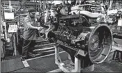  ?? SCOTT STRAZZANTE/CHICAGO TRIBUNE ?? Harrison Conley works the assembly line at Navistar in Melrose Park in November 2010.