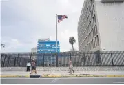  ?? REUTERS ?? People pass the US Embassy in Havana Wednesday.