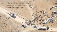  ?? — AFP ?? Iranian rescue teams gather in the area of a search operation for the wreckage of a plane in Iran’s Zagros mountain range.