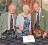  ?? Photograph: Iain Ferguson, the Write Image. ?? Marion MacDonald cuts the celebratio­n cake with her husband Rory, right, and Kenneth MacKenzie to mark the 30th reunion of the Cameron Highlander­s, in the Alexandra Hotel, Fort William.